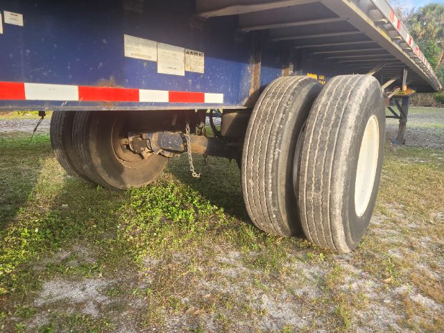 Great Dane 48x102 flatbed trailer axle view showing dual rear tires and undercarriage components.