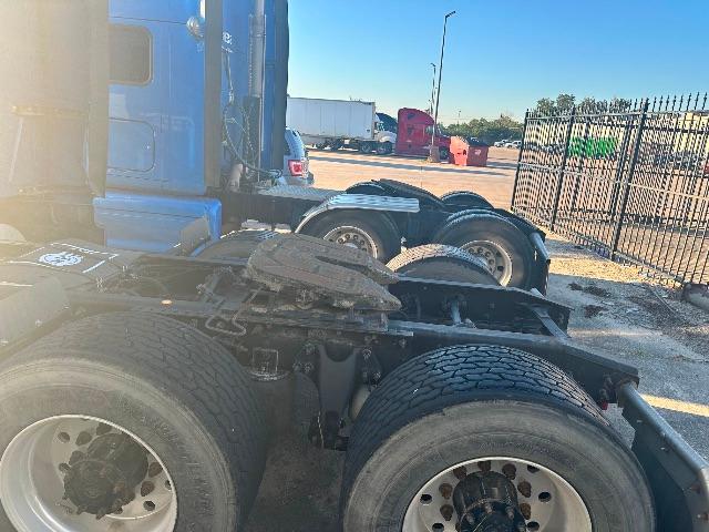 International Prostar truck chassis showing dual rear axles and fuel/tire configuration in the drive area.