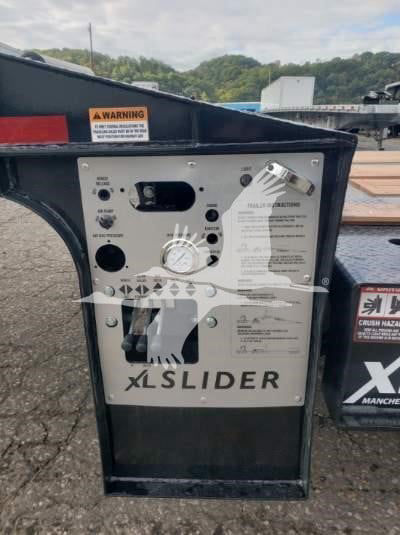 XL Sliders control panel with labels and dials; shows warning sticker, switches, and branding 'XLSLIDER' on metal panel.