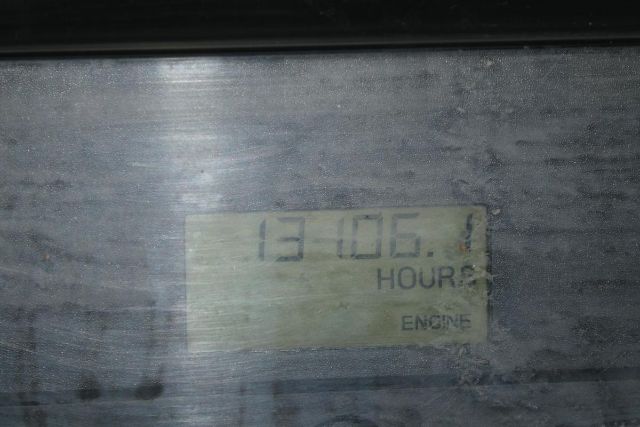 Machine instrument panel showing hour meter reading 13,106.1 hours with faded label.