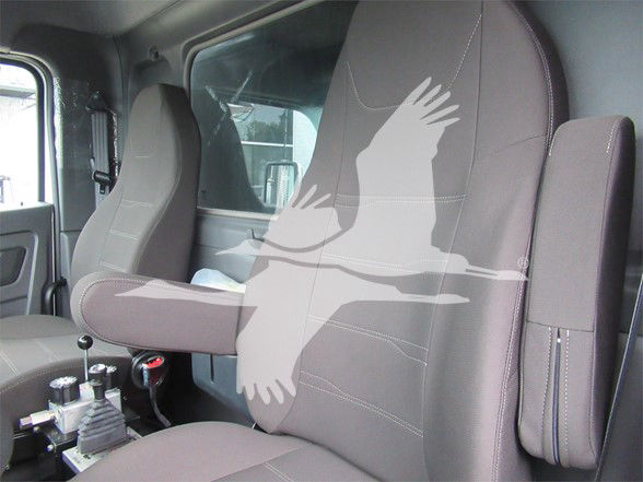 Kenworth T480 cab interior with seating; visible are driver and passenger seats with armrests, shifter, and window. Overlaid watermark obscures parts of seats.