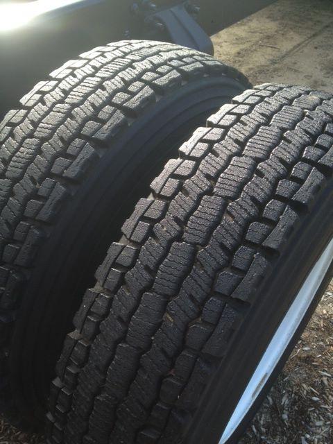 Tires mounted on Freightliner M2106 cab and chassis showing heavy tread pattern.