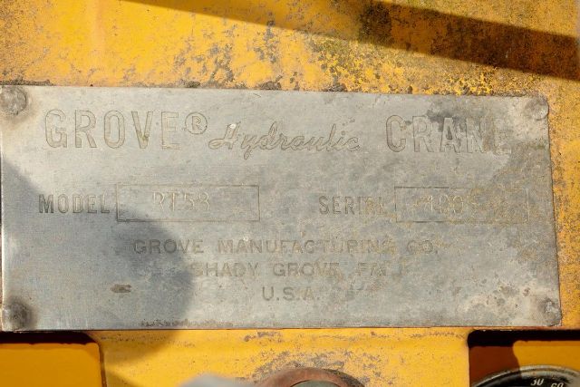 Grove Hydraulic Crane metal nameplate on yellow equipment showing GROVE Hydraulic CRANE with model and serial fields.