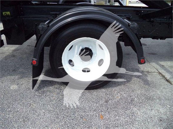 Isuzu NRR wheel arch and spare tire mount with white wheel and black fender, no visible text.