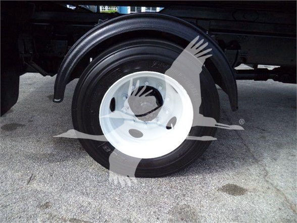 Hub and tire of a truck with partial wheel well visible.