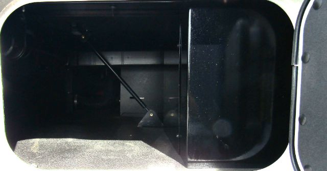 Image shows a compartment in a 2020 Kenworth T680 cab/ chassis with internal metal framework and a winch or support cable. No legible labels or fluid info visible.