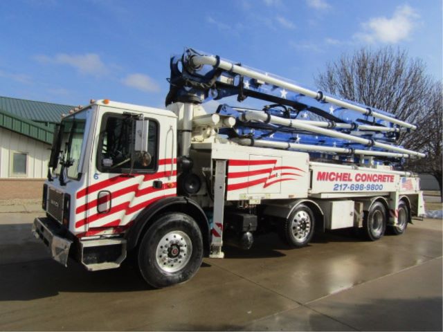 Concrete pump truck showing long blue pumping arm and white cab with red stripes.