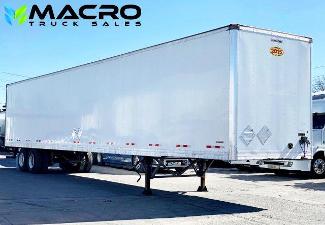 2015 Manac dry van trailer in a parking lot showing tandem axle config and rear doors with a small yellow 2015 sticker; MACRO TRUCK SALES logo overlaid.