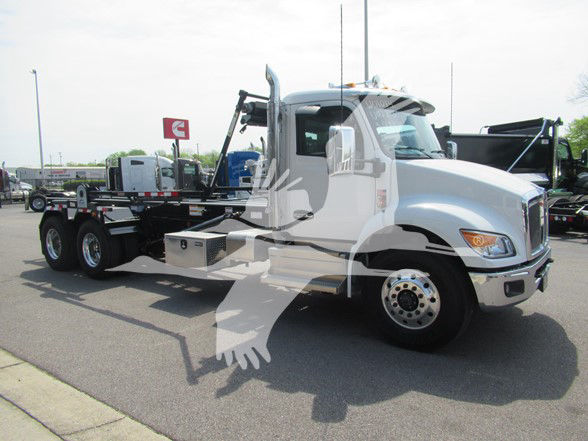 Kenworth T480 truck in a lot, side view showing cab and flatbed chassis with crane and utility boxes.