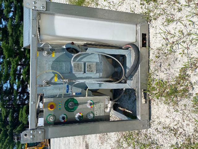 Industrial vapor blasting or vapor blaster machine with control panel, gauges, hoses, and a large tank inside a metal frame.