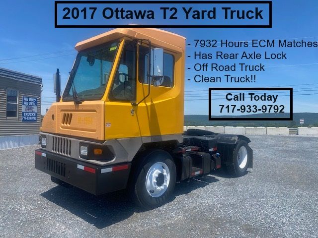 2017 Ottawa T2 yard truck with yellow cab, black bumper, and black chassis showing features: rear axle lock, off-road capability; text overlays list - 2017 Ottawa T2 Yard Truck.
