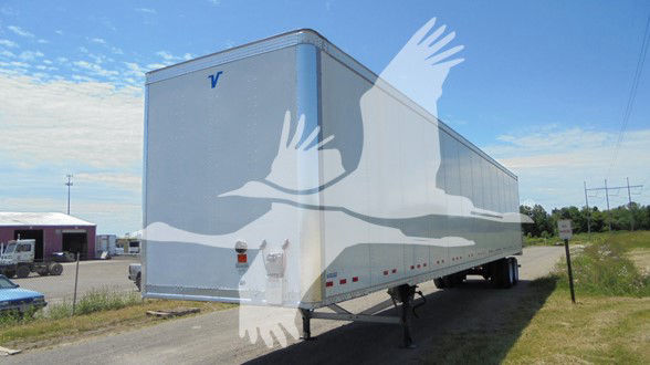 Vanguard VXP trailer in-service showing box trailer with V logo on front corner and wheel area, side profile, and landing gear.