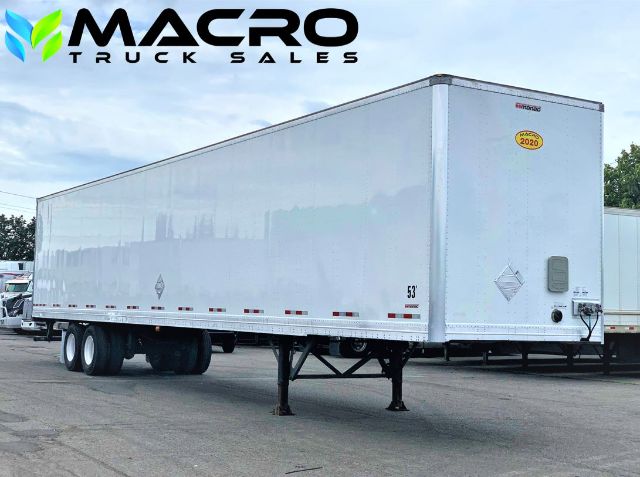 Manac dry van trailer with MACRO Truck Sales watermark; side view showing silver aluminum trailer, landing gear in front, sticker with year 2020 on nose.