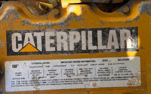Caterpillar engine plate on yellow metal indicating CAT Caterpillar 3126 engine information with model and specifications.