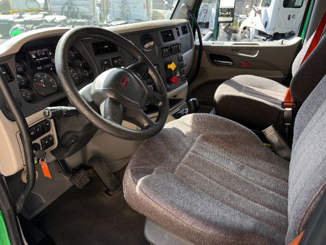Peterbilt 579 truck cab interior with steering wheel, dashboard, and driver's seat visible.