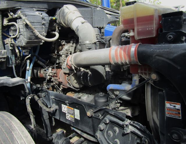 Kenworth T680 engine bay showing turbocharger, intercooler hose, coolant reservoir, and various hoses and components.