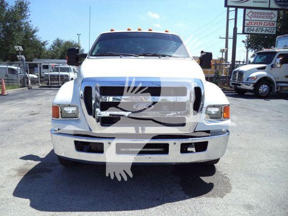 Front view of a white 2015 Ford F650 XLT truck in a dealership lot.