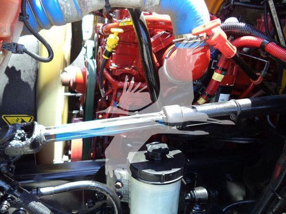 Engine bay with red engine, blue hoses, and a coolant reservoir; visible labels include no clear legible text.