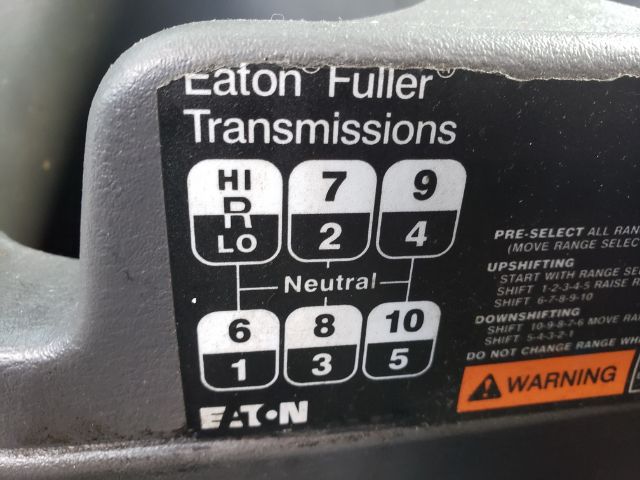 Truck dashboard shift pattern label showing Eaton Fuller Transmissions with gears HI/LO and neutral, 2/4/6/8/10/12 positions on a black sticker.