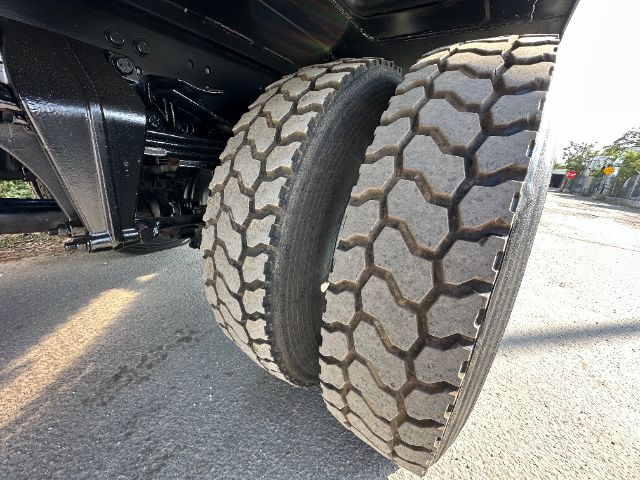 Freightliner 108SD dual rear tires view showing tread pattern and suspension components.