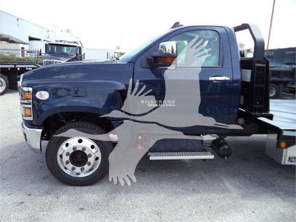 Chevrolet Silverado 6500HD truck side view showing cab and chassis with step, wheel, and logo text visible.