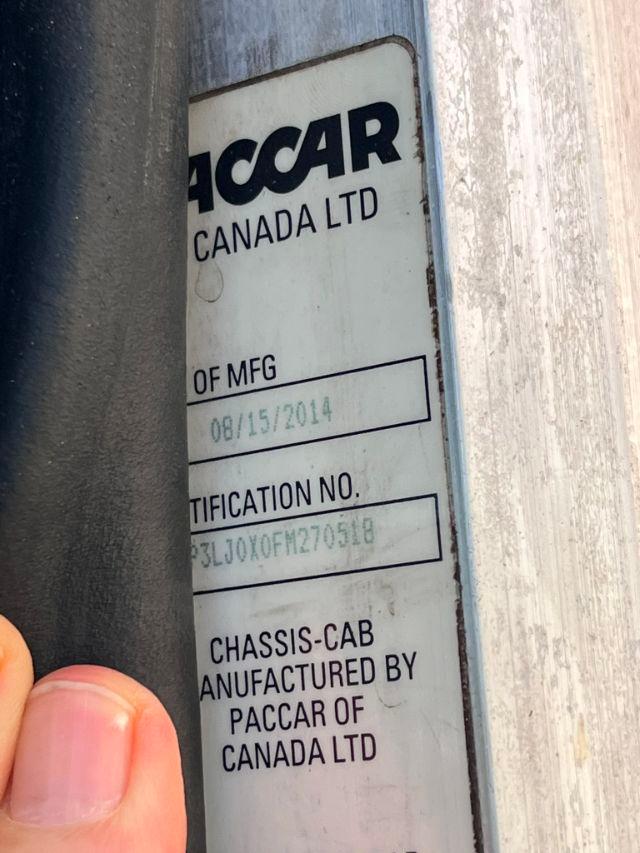 Label on a vehicle showing PCCAR CANADA LTD, OF MFG, 08/15/2014, CERTIFICATION NO., CHASSIS-CAB MANUFACTURED BY PACCAR OF CANADA LTD