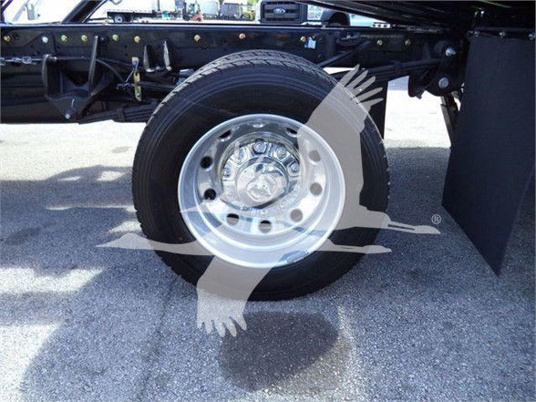 Wheel and axle area of a 2024 Ram 5500 SLT truck showing steel rim and tire undercarriage.