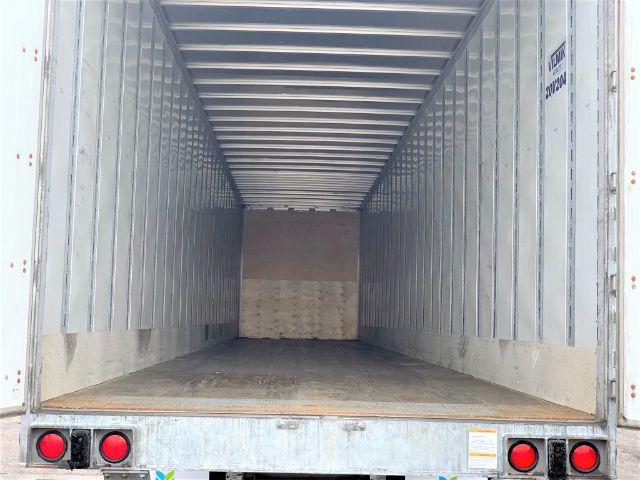 Manac dry van trailer interior showing empty cargo area with metal walls and rear door frame.