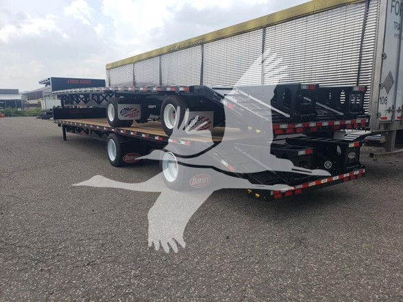 Dorsey Drop Deck Beavertail trailer showing stacked flatbed sections with dual rear axles and beavertail ramp area; side branding and trailer tires visible.