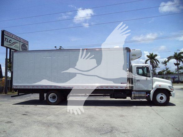Truck with refrigerated body, side view showing a white cab and a long box trailer, stock number 26198RFM, palm tree background.