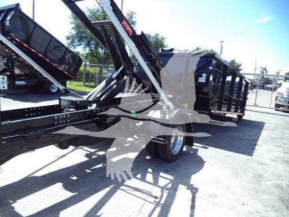 Ram 5500 HD truck bed with dump/dump trailer equipment, black metal framework, tires, and storage enclosures; no legible serials or model numbers visible.