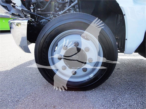 Chevrolet Silverado 5500HD front wheel and tire close-up with partial truck body, stock number J82601, category Refuse, new vehicle.