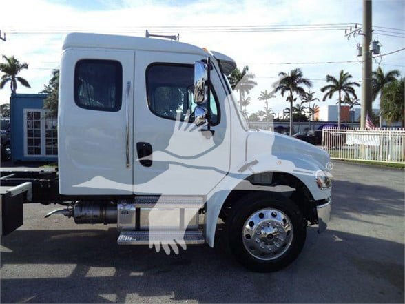 Freightliner BUSINESS CLASS M2 106 PLUS cab with side exhaust and chrome wheel, front wheel view.