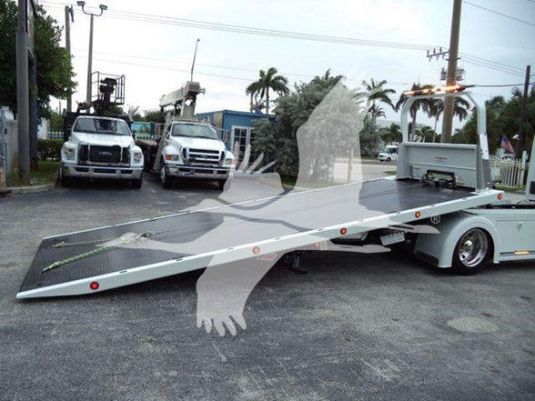 Tow truck with flatbed indicating 2025 Kenworth T280 stock KW1STEPSIDEWHT in front of other trucks.