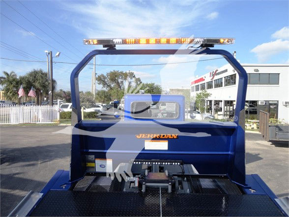 Peterbilt 337 truck rear view showing blue hardware, overhead warning light bar, and tail area with ‘JERREN’ branding and glass rear window.