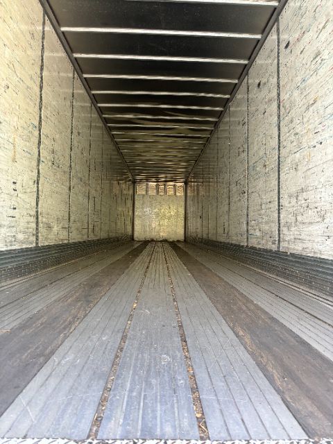 Wabash van trailer interior showing corrugated metal walls and floor with longitudinal ridges.