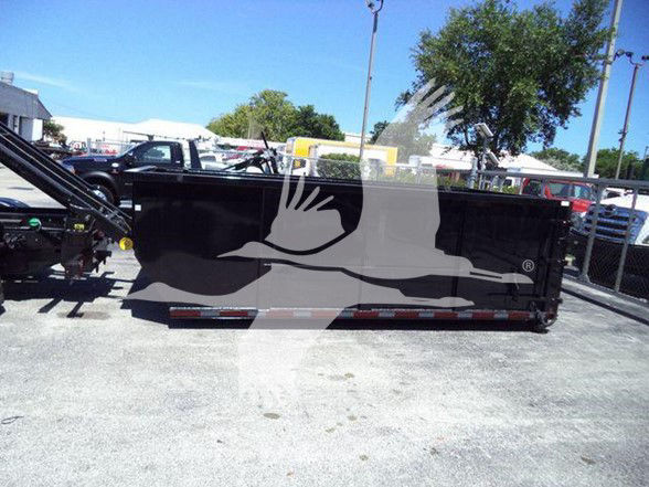 Truck dump bed in a dealership lot showing side panel with no text visible.