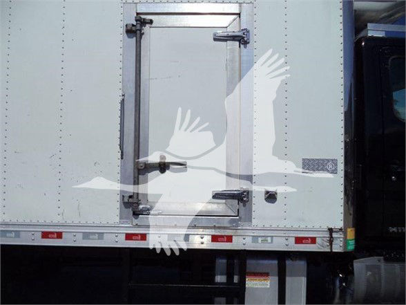 Truck reefer unit with rear cargo door and latch hardware; faint white bird graphic overlaying the side.