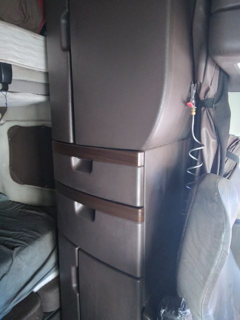 Volvo engine bay showing interior sleeper cab area with center console and seat back in view.