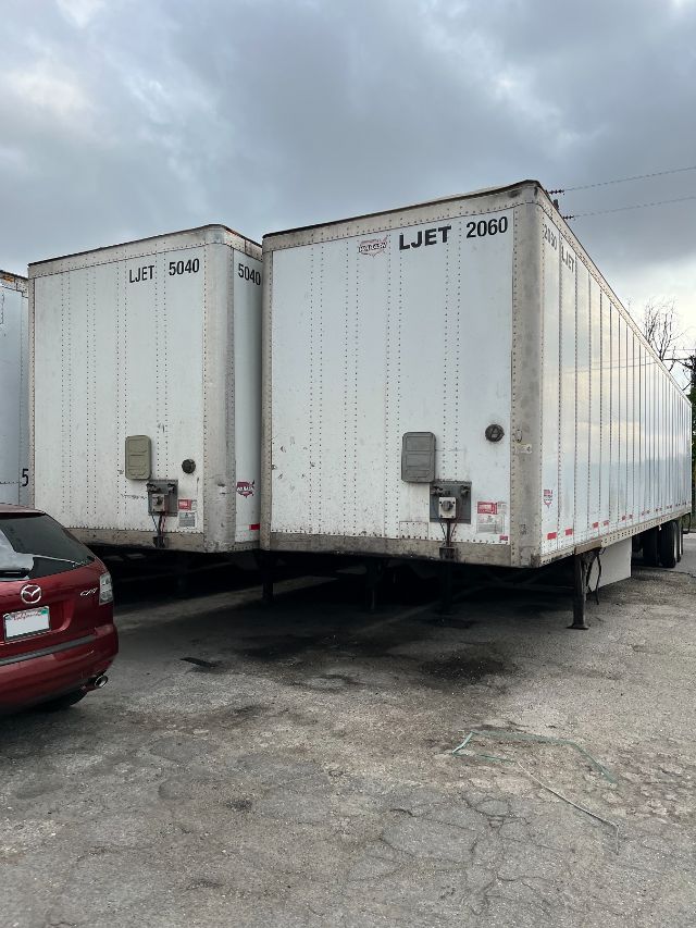 Two white 53' dry van trailers in a lot with doors closed, showing LiJet-5040 and LiJet-2060 markings on doors and rear area.