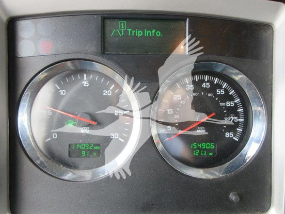Kenworth W900L dashboard showing Trip Info display, two round gauges with digital readouts: left gauge shows 0-30 with needle near 0, green digital readout at bottom shows 11409.2 hrs and 9.1?; right gauge shows 0-85 with needle at around 7