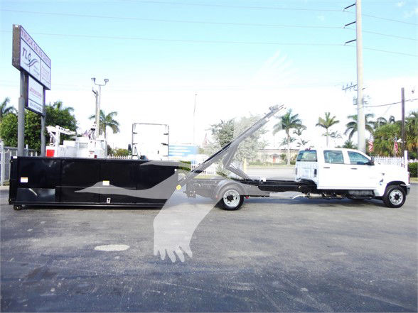 2023 Chevrolet Silverado 5500HD flatbed truck with tow setup in a dealership lot, stock number J82601, new category Refuse.