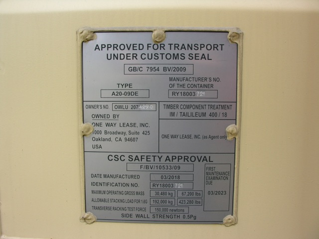 Container trailer rear safety plate showing CSC safety approval, manufacturing date 03/2018, identification number RY18003 721, maximum operating gross mass 30,480 kg / 67,200 lbs, allowable stacking load 192,000 kg? (text partially).