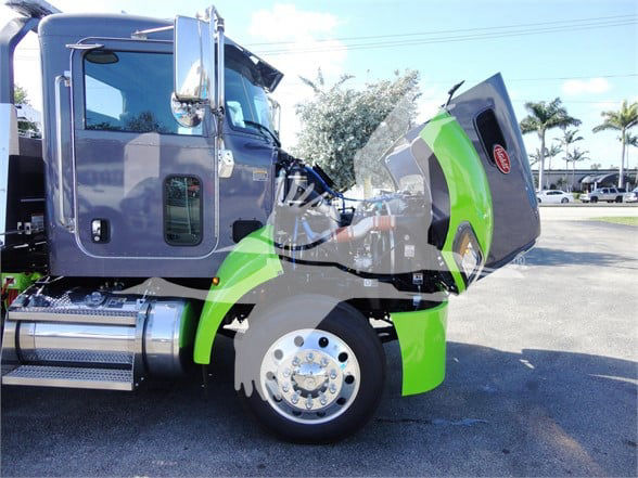 Graphic image of a 2022 Peterbilt 337 tow truck with the hood open, showing the front wheel, steps, and cab door.