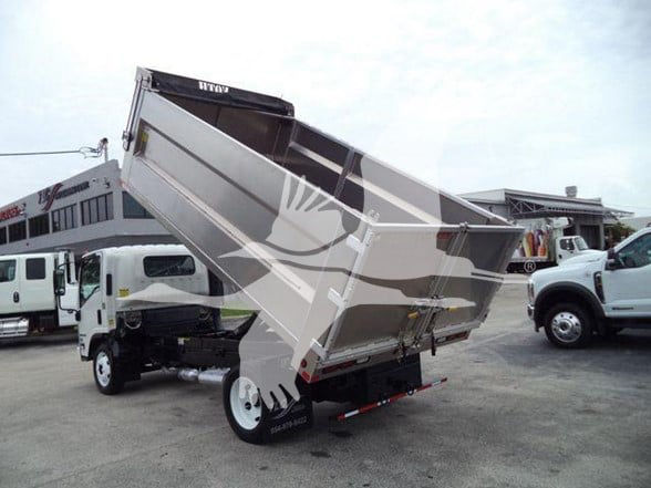 Isuzu NPR HD dump truck with bed raised, side view showing dump body and dual rear wheels.