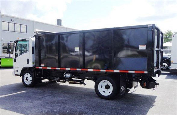 Isuzu NPR HD dump truck side view showing black dump body and white cab