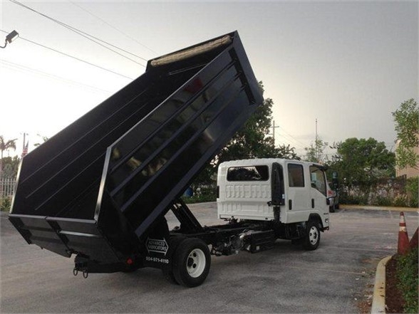 Advanced Fabricators 14 ft dump bed on a white cab truck with the bed raised