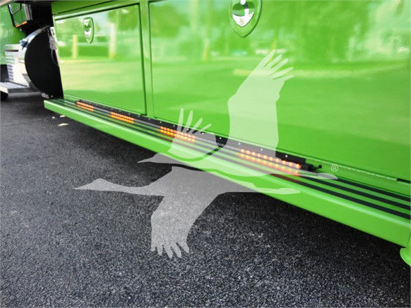 Peterbilt 337 side step with green paint and running boards showing LED lights and lower side panel.