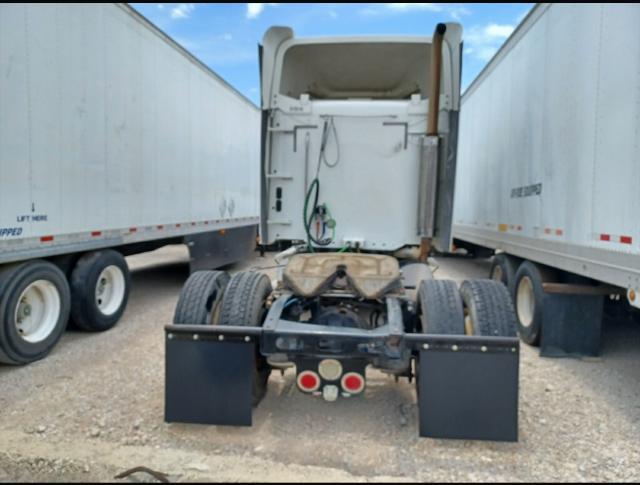 Freightliner Columbia 2007 tractor rear view showing fifth wheel, dual rear axles, mudflaps, and tail lights. Sleeper cab visible, parked between two trailers.