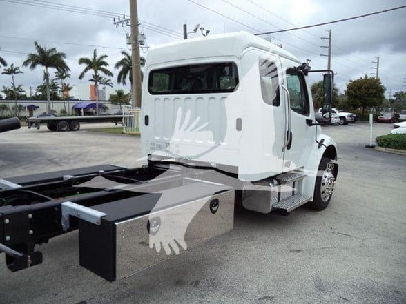Freightliner Business Class M2 106 cab showing side view with tow chassis and front wheel